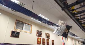 A model of a modern satallite which hangs from the ceiling in the reception area of RAF Menwith Hill